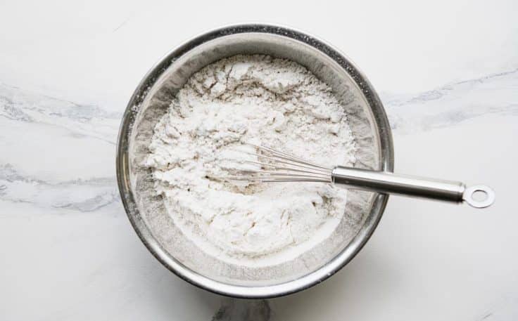 Dry ingredients whisked together in a metal bowl.