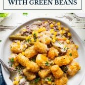 Tater tot casserole with green beans and text title box at top.
