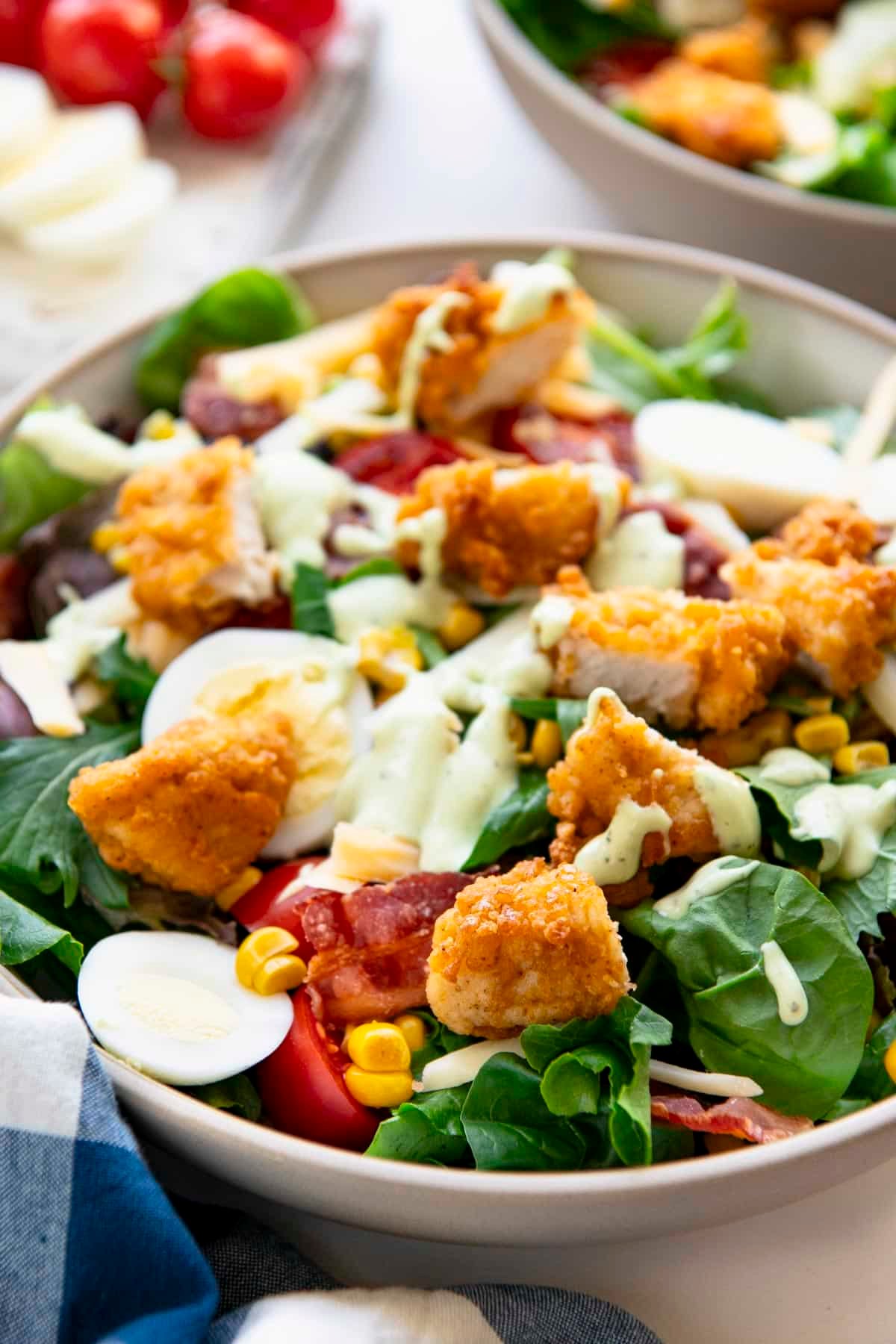 Close up side shot of a cobb salad recipe in a bowl.