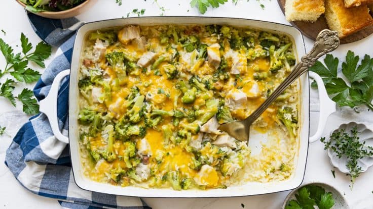 Overhead image of dump-and-bake chicken broccoli rice casserole in a white dish.