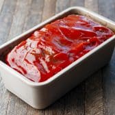 Adding the ketchup on top to a meatloaf with oatmeal.