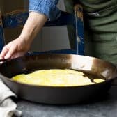 Cooking eggs in a cast iron pan.