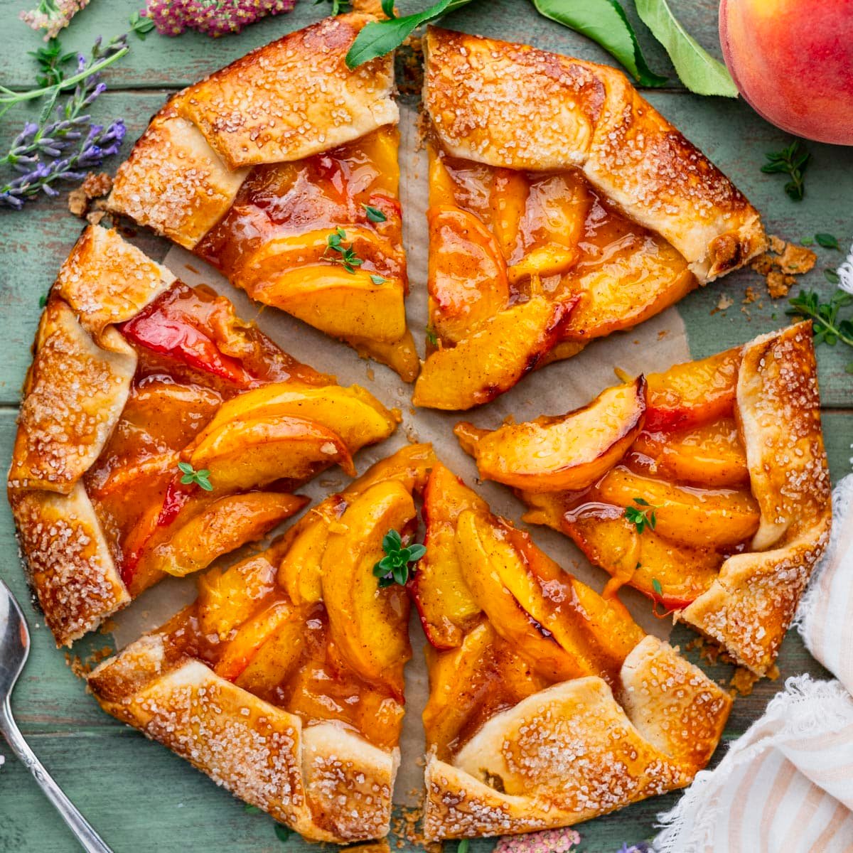 Square overhead shot of a sliced peach galette.