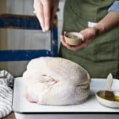Process shot showing how to season turkey breast.