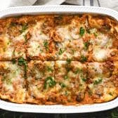 Horizontal overhead shot of a sliced vegetable lasagna in a white dish.