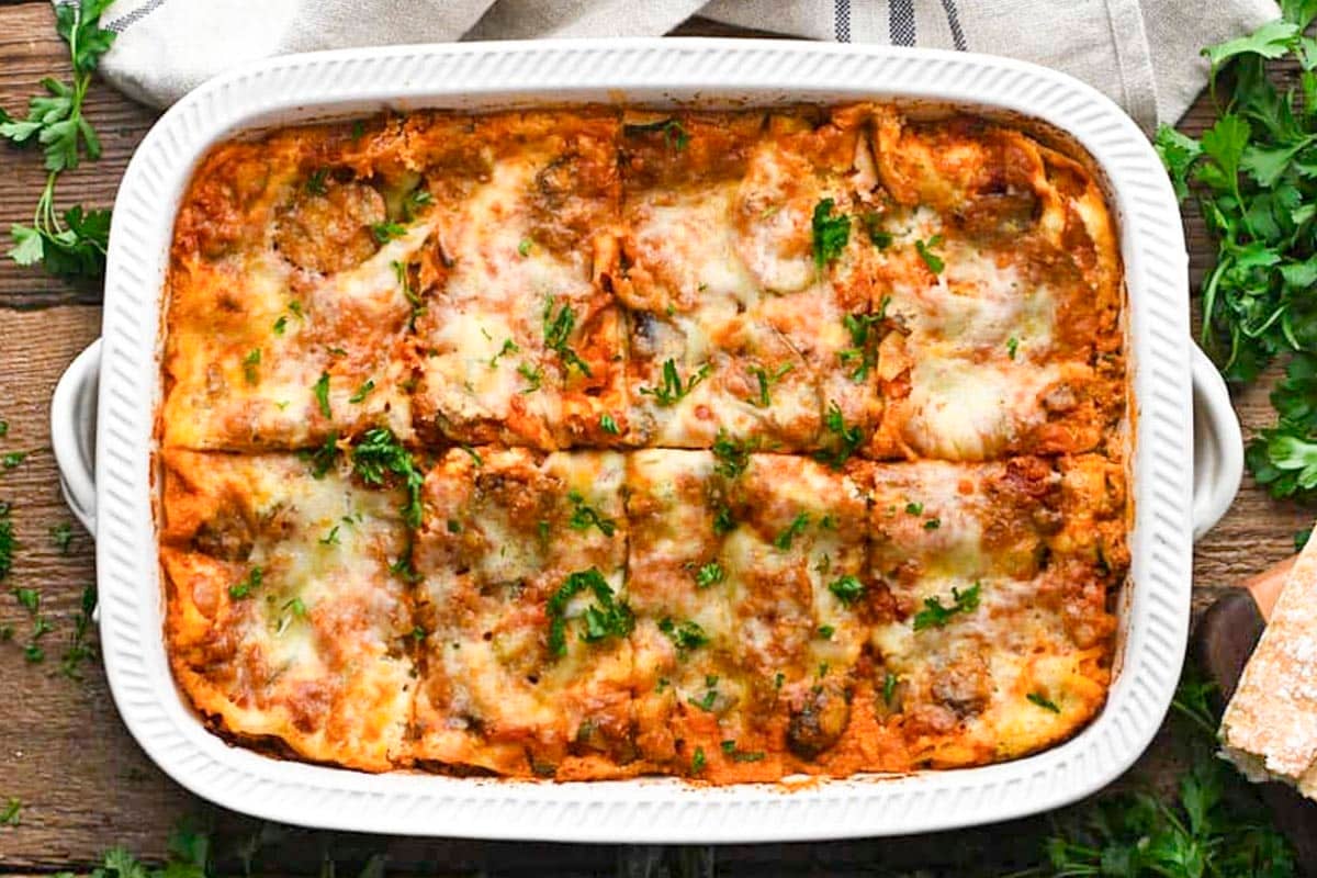 Horizontal overhead shot of a sliced vegetable lasagna in a white dish.