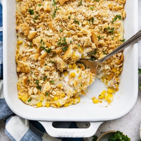 Square overhead shot of Amish chicken and corn casserole in a white baking dish.