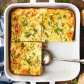 Square overhead shot of a baked western omelet in a white dish.