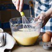 Whisking together eggs for a baked western omelette.