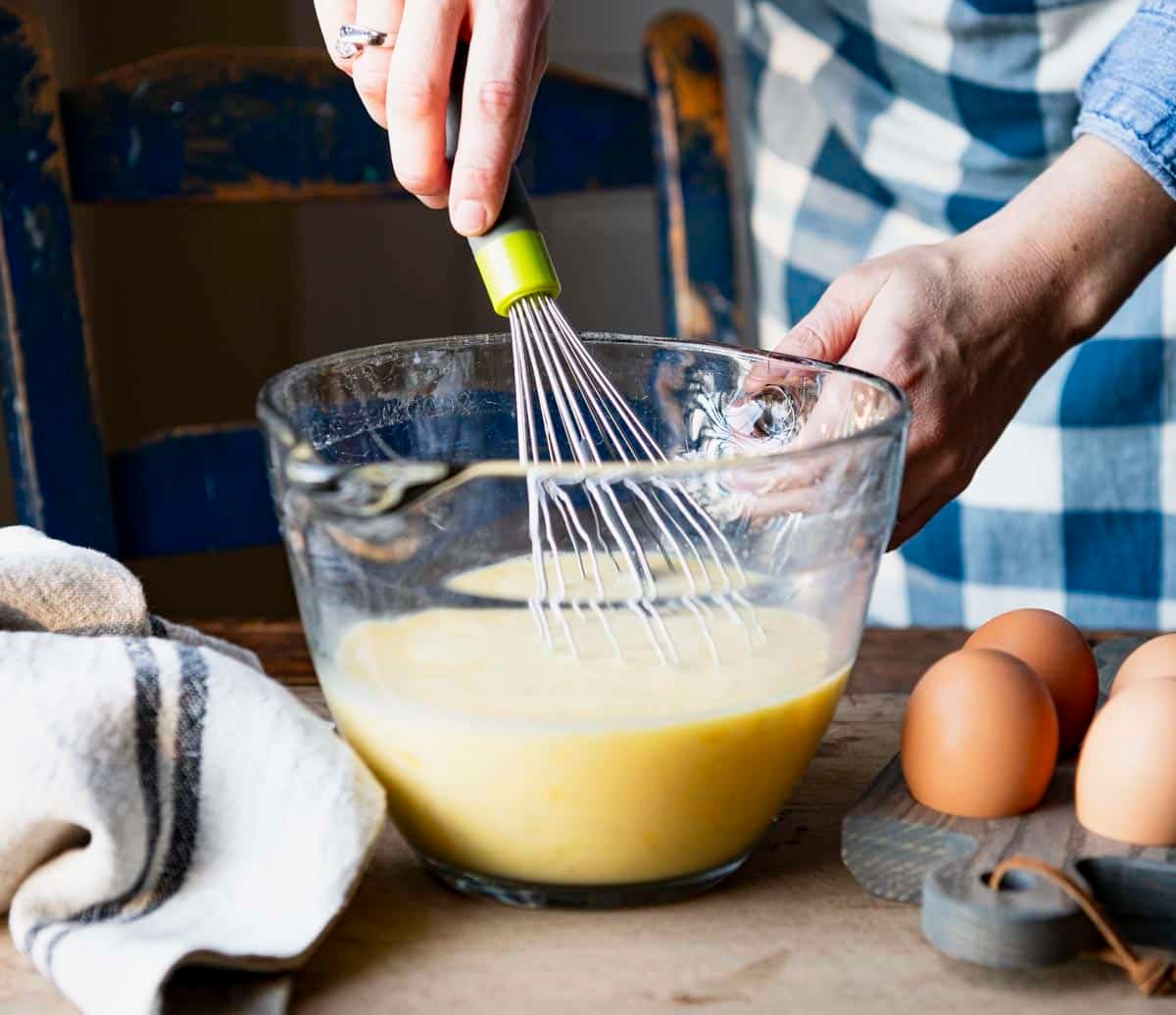 Whisking together eggs for a baked western omelette.