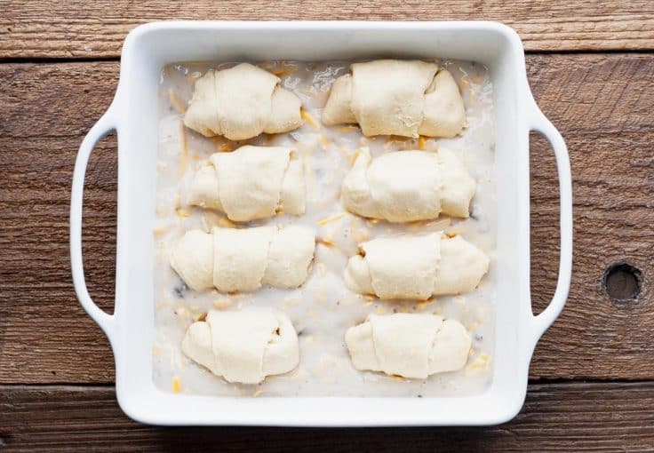 Overhead shot of chicken crescent rolls in a dish before baking.