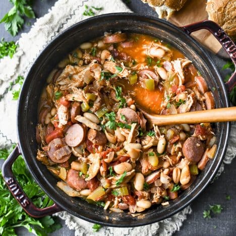 Square overhead shot of an easy cassoulet recipe in a cast iron Dutch oven.