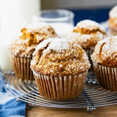 Square side shot of one-bowl easy pumpkin muffins cooling on a wire rack.