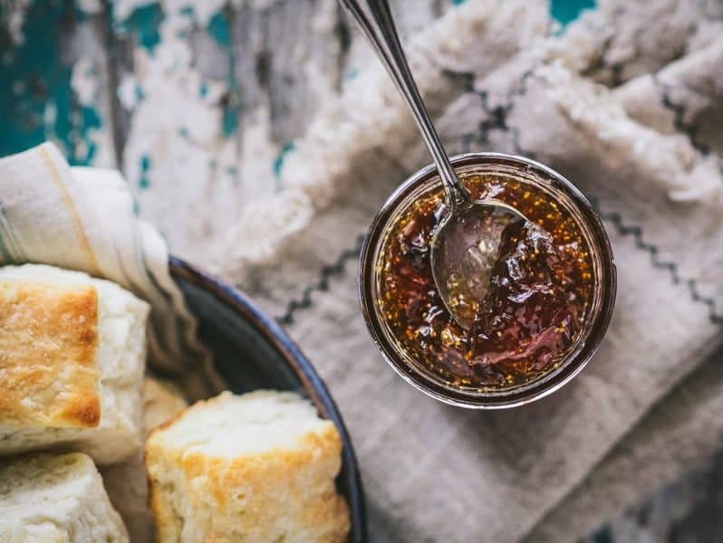 Overhead shot of a spoon in a jar of fig jam