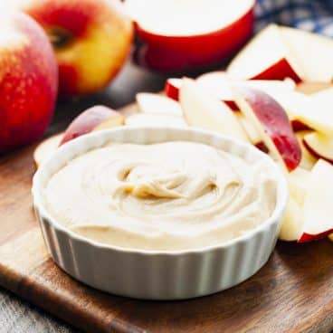 Square front shot of apple dip in a white bowl.