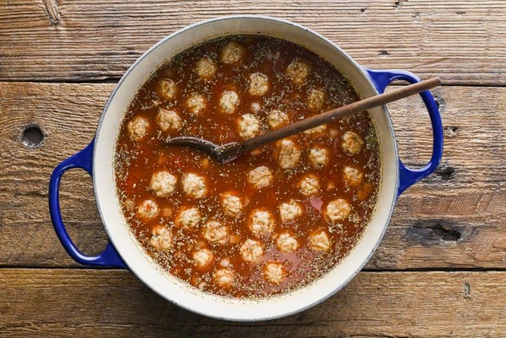 Process shot showing how to make meatball tortellini soup.